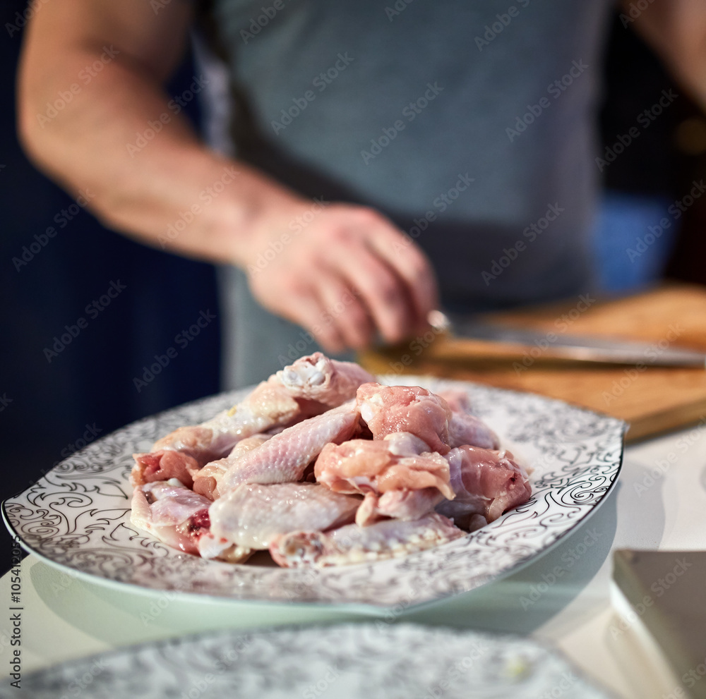 Man chopping chicken wings