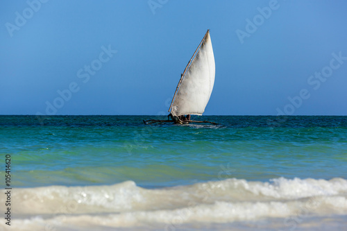 old wooden sailing boat African glides over the waves of the Ind