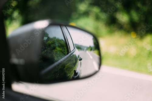 View From Car Window on Mirror. Travel Concept