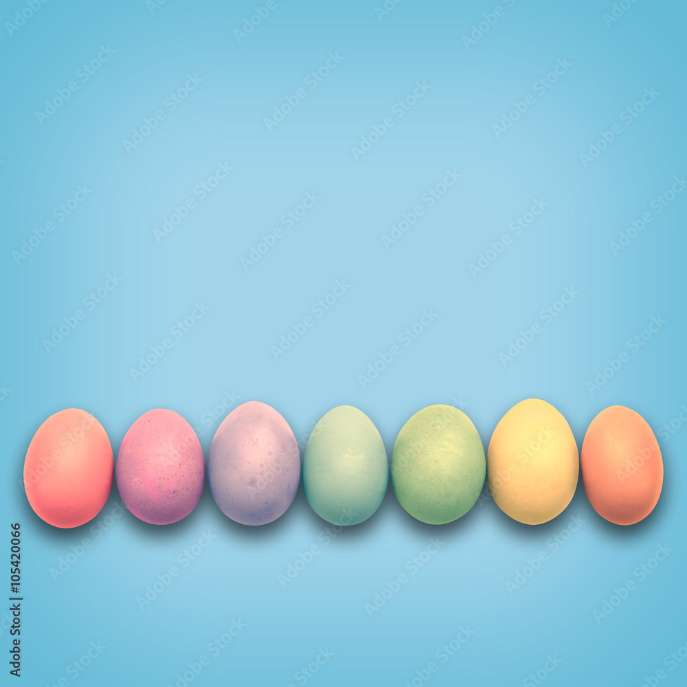 Pastel Easter eggs aligned, blue background Pastel Easter eggs aligned, blue background
