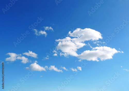 Blue sky with white cumulus clouds. Cloudscape in the sun  good weather with copy space. Nature background with clear blue sky and fluffy clouds.