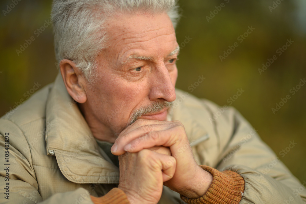 thoughtful senior man in park thoughtful senior man in park