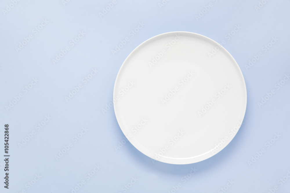 empty plate on a blue background empty plate on a blue background