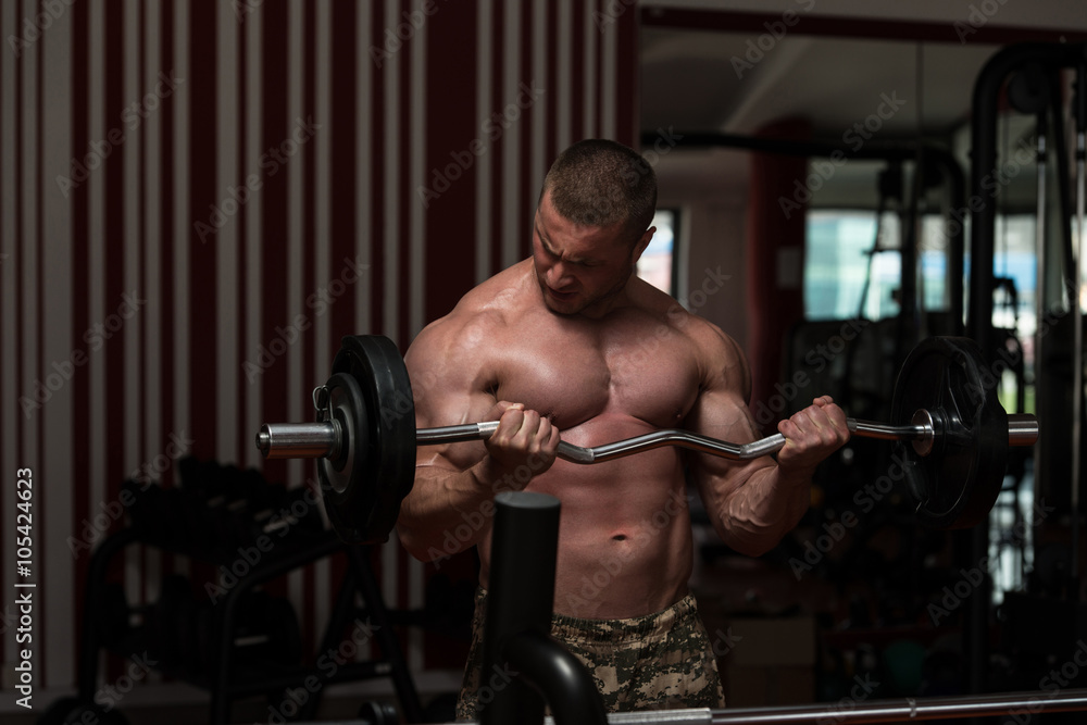 Young Man Doing Exercise For Biceps Young Man Doing Exercise For Biceps