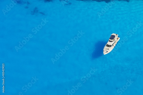 Aerial view of single yacht in azure sea