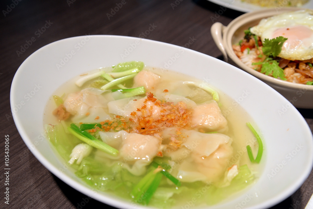 Chinese style wonton soup in white bowl
