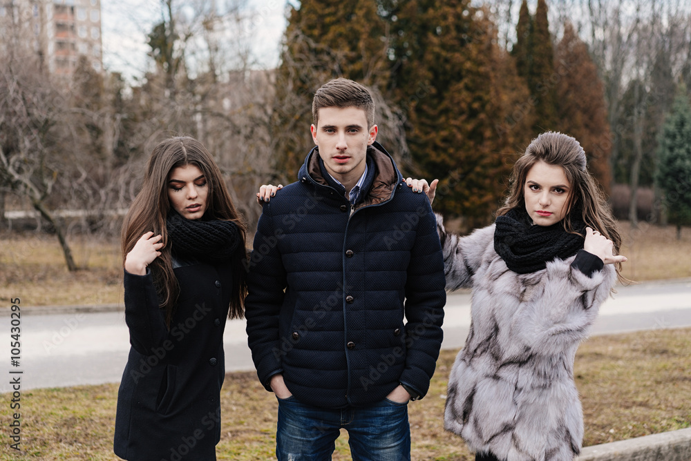 Three beautiful people in the autumn park Three beautiful people in the autumn park