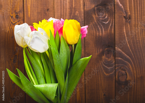 Bouquet Of Tulips In Front Of Spring Scene On The Wooden Background. A bouquet of flowers for March 8, or Valentine's day