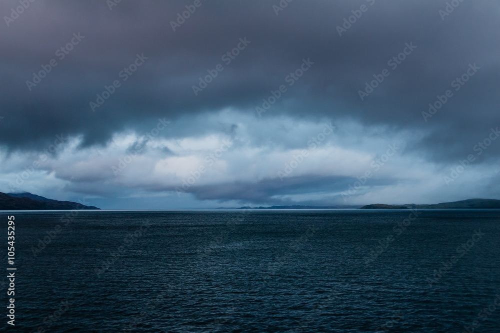 Fototapeta premium Eye shaped gathering storm at dusk near Mull, Scotland