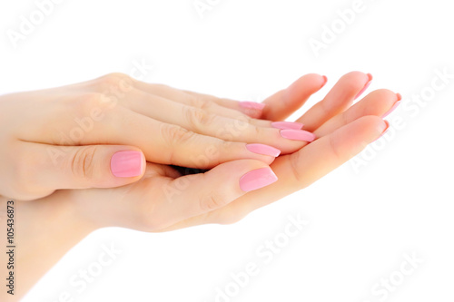 Closeup of hands of a young woman with pink manicure on nails isolated on white background