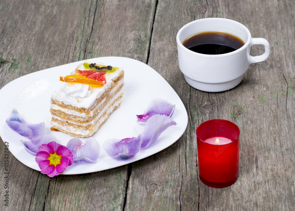 plate with cake decorated with flowers, coffee and a candle, a s