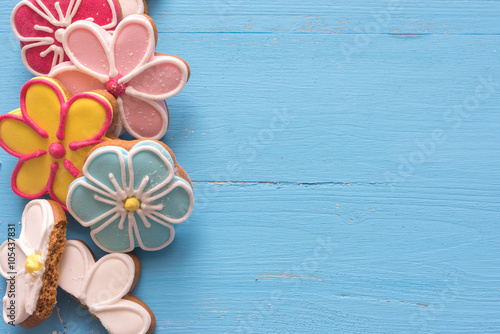 Happy Easter  (home-baked cookies) 
Flower shaped gingerbread cookies on a blue wooden table.
