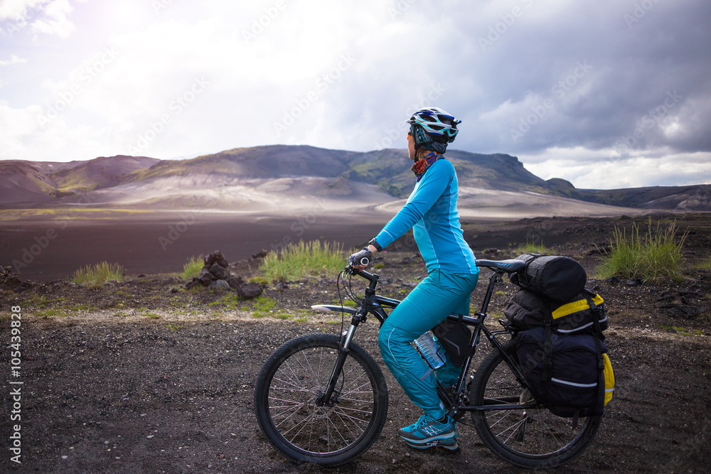 Fototapeta premium Happy biker on backdrop of volcanic mountains in Iceland