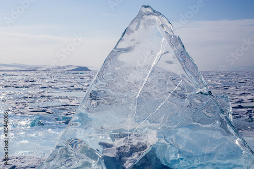 A transparent hummocks  on the surface of the blue frozen Lake Baikal