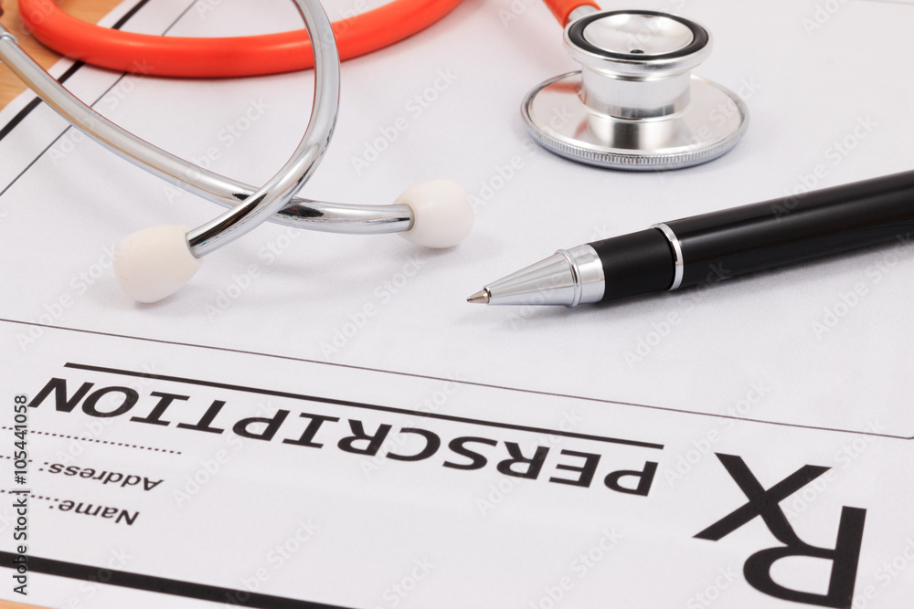 Closeup of red stethoscope and pen on a rx prescription. Closeup of red stethoscope and pen on a rx prescription.