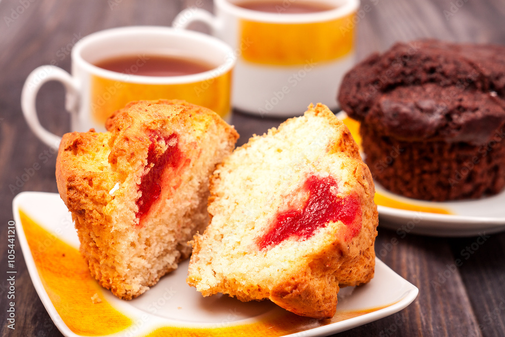 Cupcakes with tea on black wooden background Cupcakes with tea on black wooden background