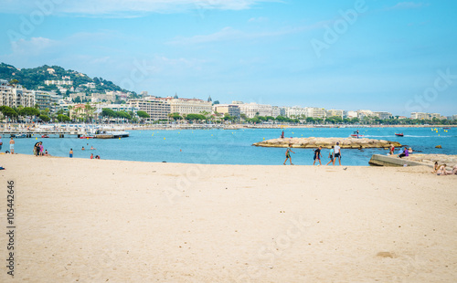 People on the most popular beach in Cannes, France - Plage de la Croisette - the famous beach on the Croisette, known for its film festival.