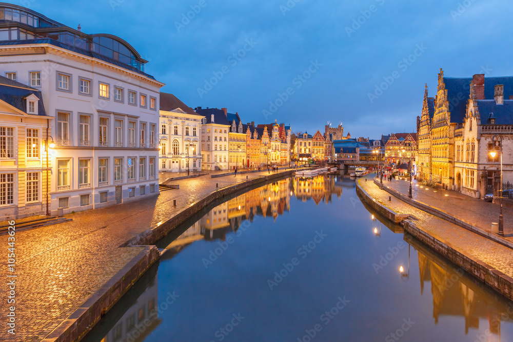 Picturesque medieval buildings on quay Korenlei and  quay Graslei,  Leie river in the evening, blue hour, Ghent, Belgium