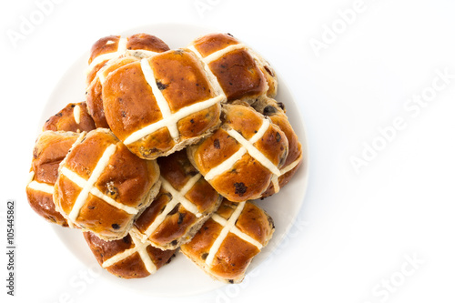 A plate full of Easter, hot cross buns on an isolated white background. View from above looking down.