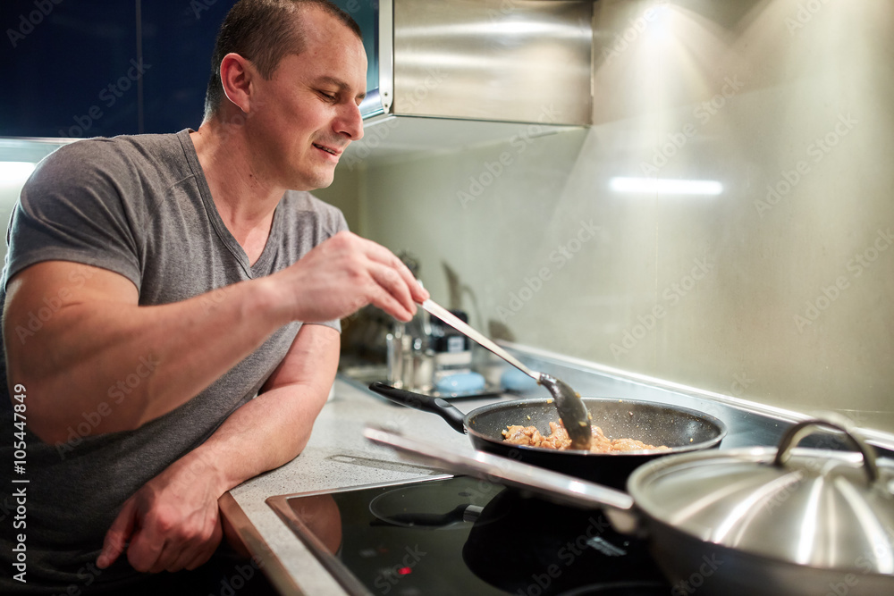 Man cooking at home alone Man cooking at home alone