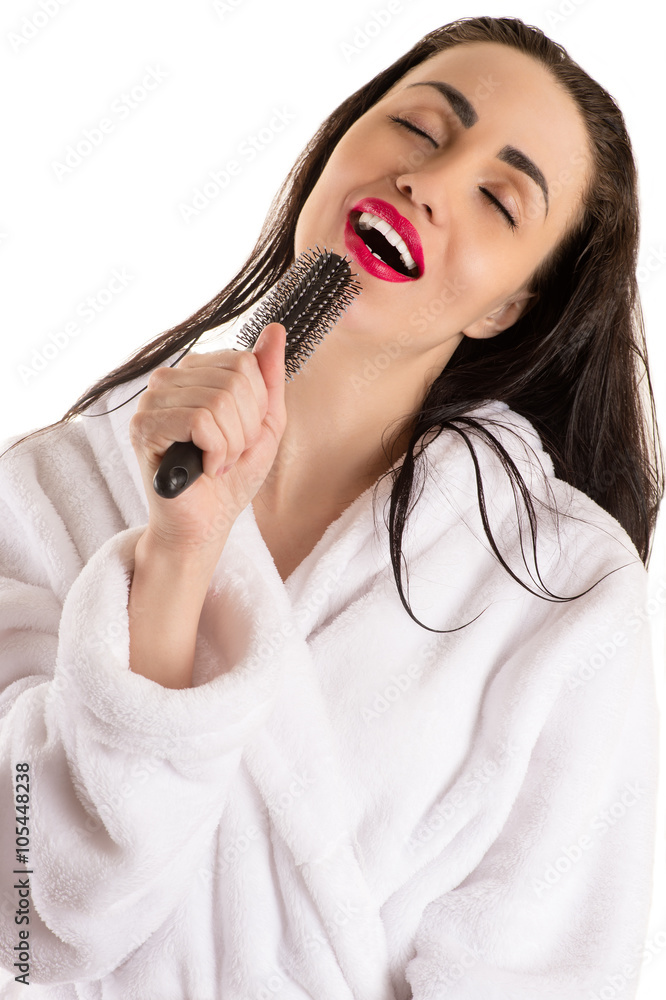 attractive woman with wet hair singing into hairbrush attractive woman with wet hair singing into hairbrush