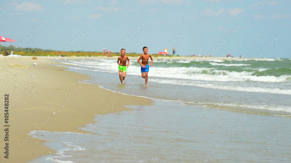 Two happy children run on the seashore. Slow motion. Full hd 1920x1080 Two happy children run on the seashore. Slow motion. Full hd 1920x1080