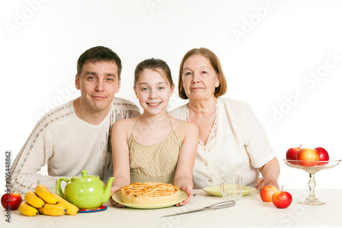 the grandmother and the granddaughter treat the father with pie