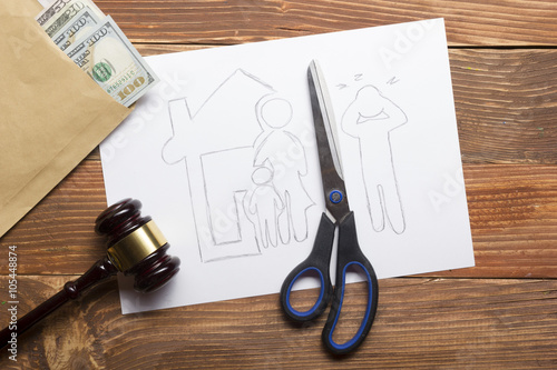 Family law concept. Divorce section of the property by legal means. Scissors cutting paper 