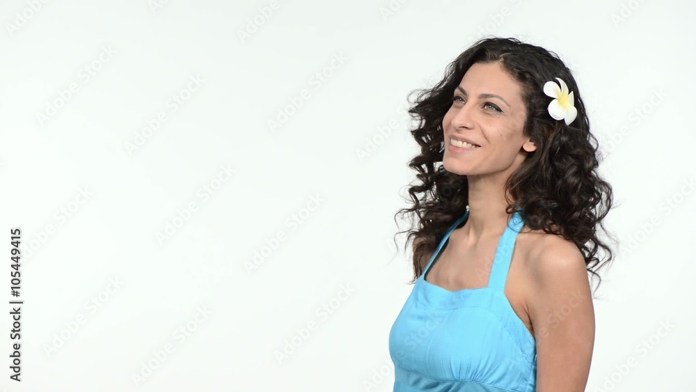 Woman with hair fluttering on the wind, blowing a kiss at camera Woman with hair fluttering on the wind, blowing a kiss at camera
