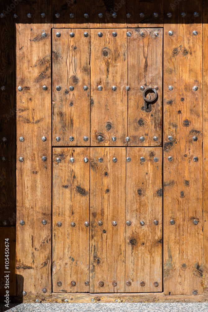Ancient wooden door with metal handle Ancient wooden door with metal handle
