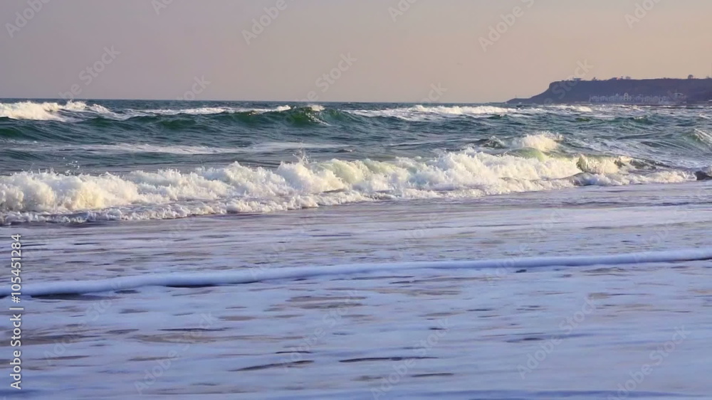 Waves on Sandy Beach at Sunset