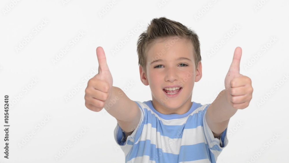 Happy expressive caucasian boy showing in the camera the thumbs up sign at studio Happy expressive caucasian boy showing in the camera the thumbs up sign at studio