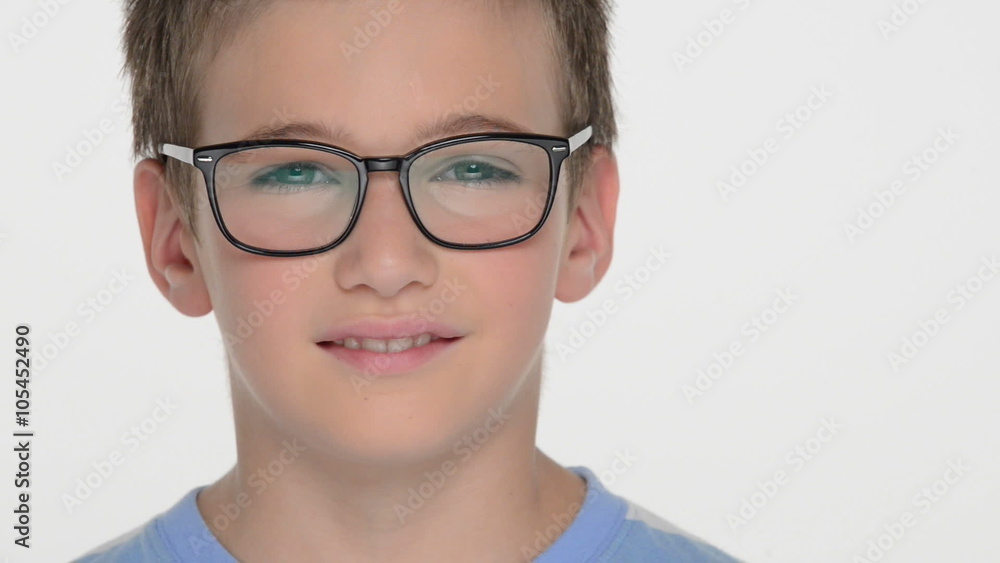 Closeup portrait of the Pretty boy of ten years, wears glasses, looks at the camera and smiles Closeup portrait of the Pretty boy of ten years, wears glasses, looks at the camera and smiles