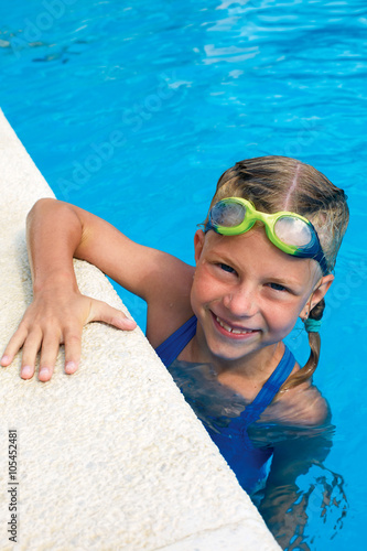 Portrait of little cute girl in the swimming pool. Sportime photo