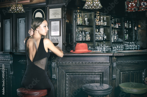 girl at the pub bar with evening dress