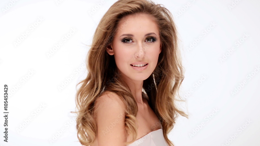 Happy beautiful young woman with long brown curly hair posing at studio Happy beautiful young woman with long brown curly hair posing at studio