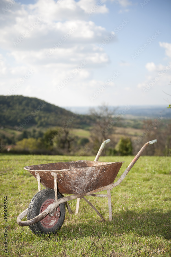 Old rusty wheelbarrow cart in the garden Old rusty wheelbarrow cart in the garden