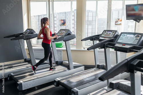 Sports woman is running on the treadmill © familylifestyle