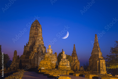 the ancient temple in the night scene with the moon at the Ayuthaya historical park Thailand