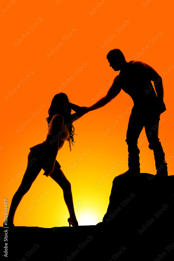 silhouette of man hand reaching down to woman silhouette of man hand reaching down to woman
