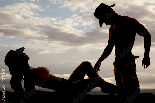 silhouette of cowgirl lay back knees up cowboy