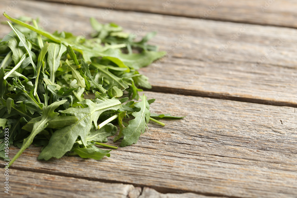 Fresh arugula leafs on a grey wooden table Fresh arugula leafs on a grey wooden table
