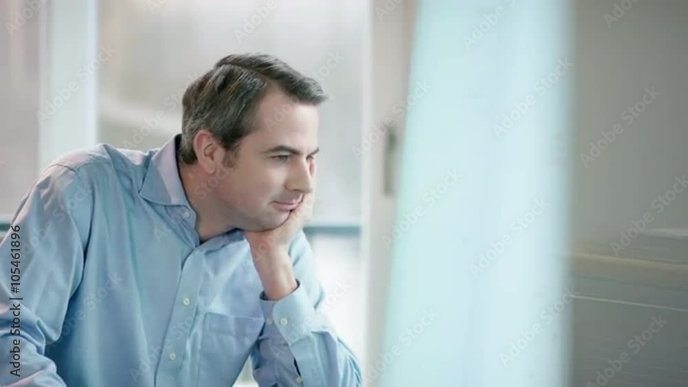 businessman at office desk looking at screen, lauqhing businessman at office desk looking at screen, lauqhing