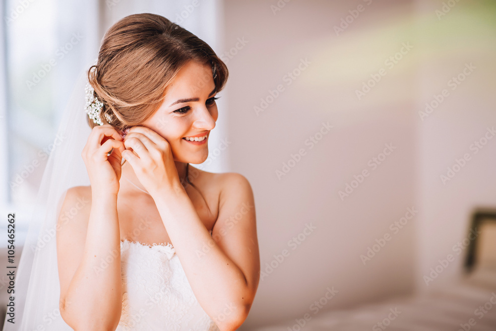 beautiful brunette stylish bride getting ready in the morning in the room