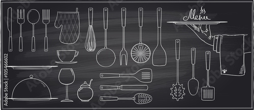 Set of kitchen utensils and tableware on a chalkboard