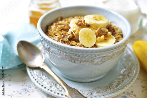 Granola with milk and banana slices.