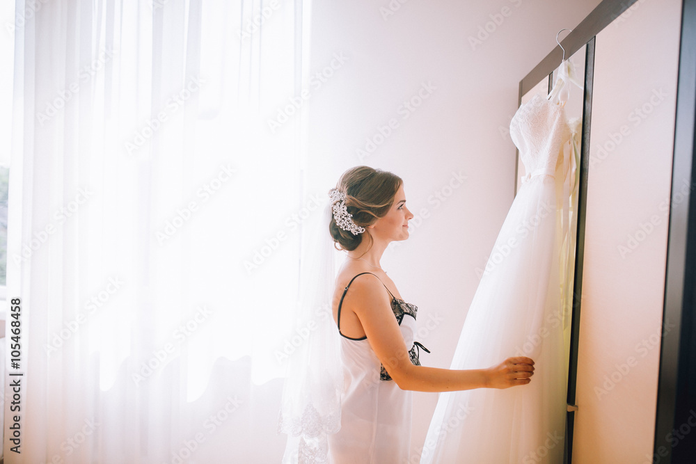 beautiful brunette stylish bride getting ready in the morning in the room
