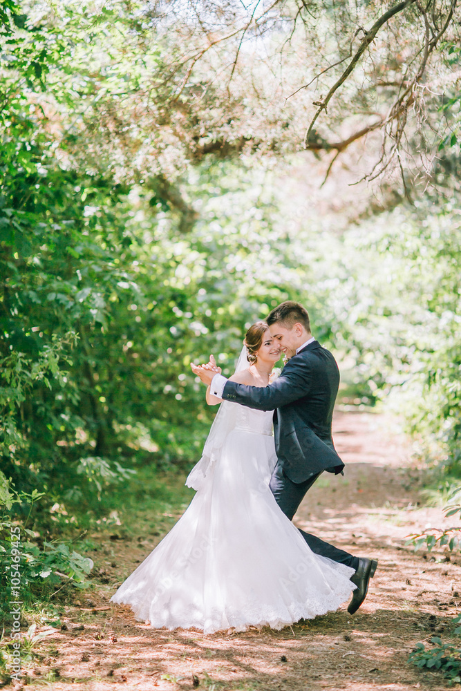 Married Couple in forest embracing and dancing