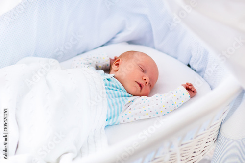 Cute newborn baby in white bed