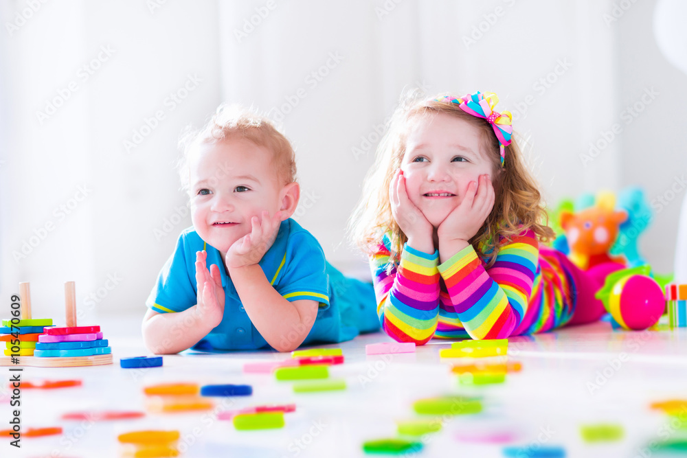 Fototapeta premium Kids playing with wooden blocks